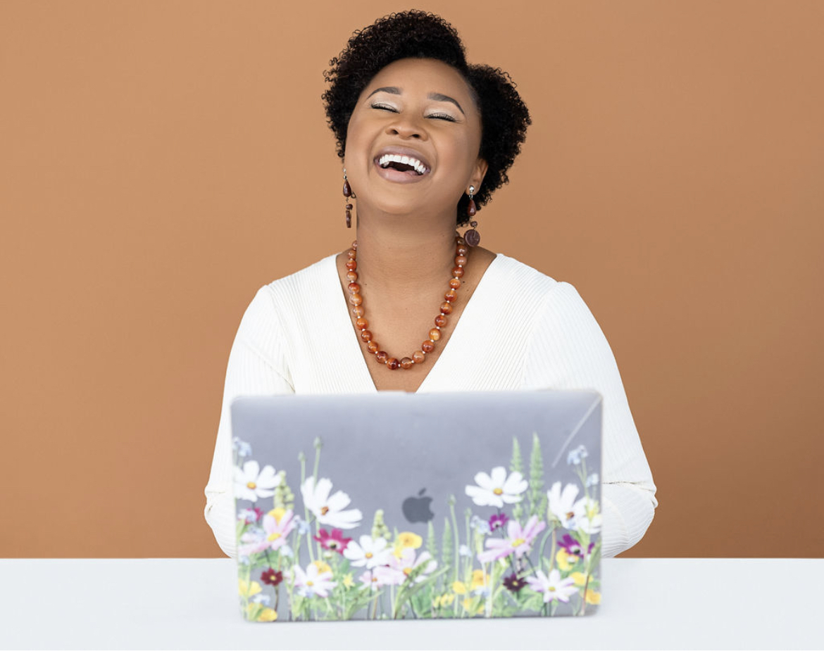 Kathryn Booker-Veloz laughing at her laptop